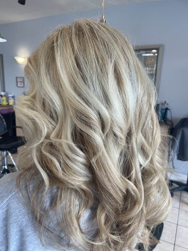 Back view of soft blonde waves with light highlights