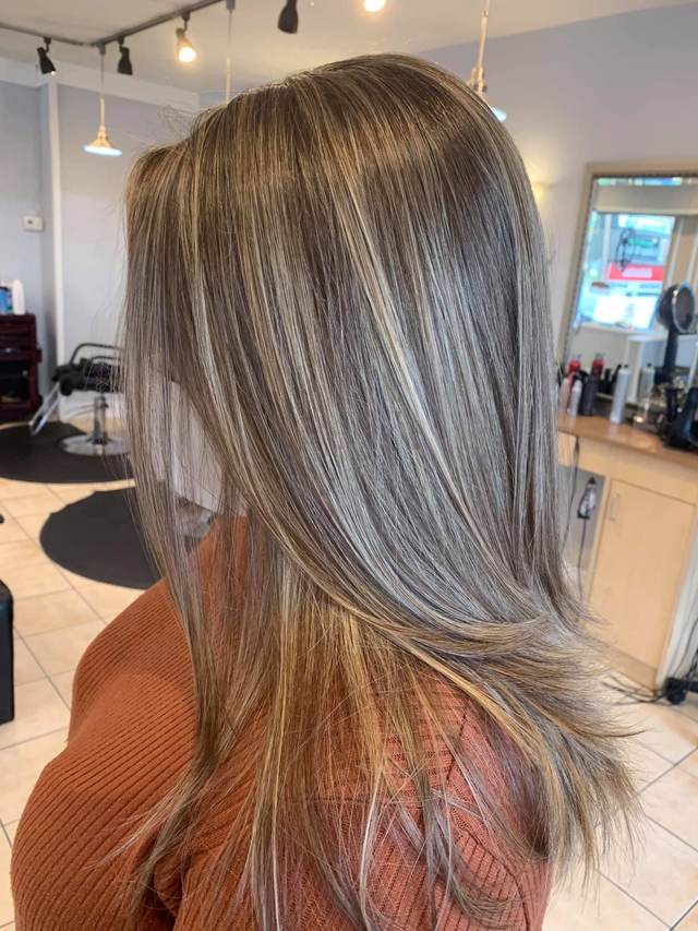 Long straight layers with soft blonde highlights