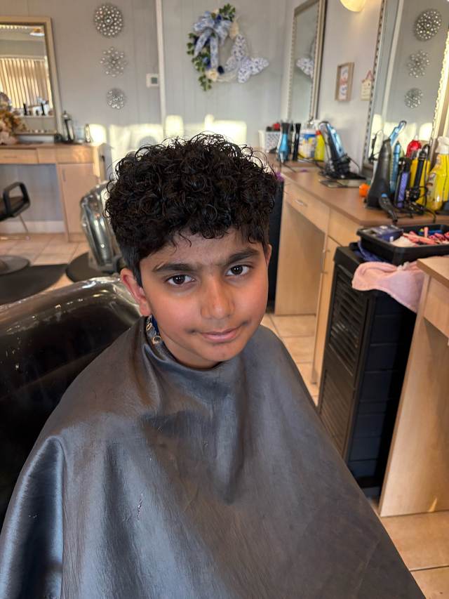 Short curly textured haircut with tapered sides